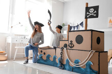 Cute Little Boy With His Mother Dressed As Pirates Playing At Home