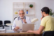 © Elnur - Young male patient visiting old male doctor