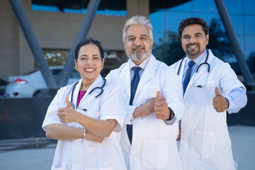 Wall Mural - Successful team of medical doctors showing thumps up