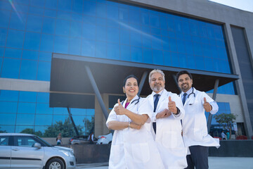 Wall Mural - Successful team of medical doctors showing thumps up