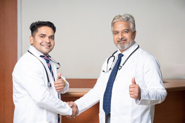 Wall Mural - Two indian doctor shake hand at hospital.