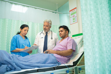 Wall Mural - Doctor check up to patient at hospital and asking to female assistant writing some medicine