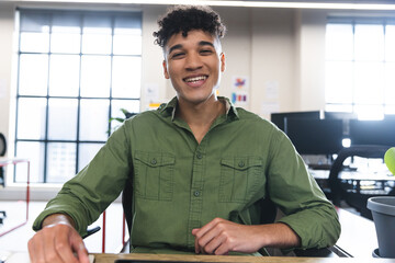 Fototapete - Happy biracial man talking looking at the camera during a video call at office