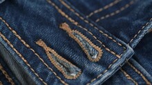 Button Holes On Blue Denim Jeans. Rotation Of Fabric Of Blue Jeans In Closeup Details. Denim Texture, Abstract Background. Clothing Concept And Tailoring.