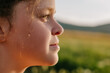 © Yura Yarema - Close up portrait of adorable happy little girl outdoors in sunset light. Cute preteen child enjoying beautiful warm sunny day standing in meadow and laughing. People freedom and childhood concept