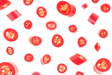 Wall Mural - Falling sliced red hot chili peppers isolated on a white background, selective focus.