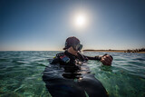 Fototapeta Do akwarium - Scuba Diver checking Dive Computer on the Surface