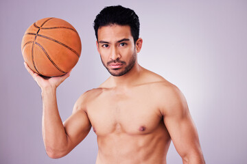 Poster - Portrait, basketball and focus with a sports man in studio on a gray background for training or a game. Fitness, body or shirtless and a young male athlete holding a ball with focus or confidence