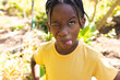 © Wavebreak Media - African american boy wearing yellow t-shirt, making funny face in garden