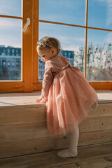 Canvas Print - little cute girl in dress near window