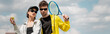 © LIGHTFIELD STUDIOS - banner, hobby and sport, stylish man and woman in sunglasses holding racket and ball on tennis court