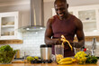 © Wavebreak Media - Happy african american man preparing healthy smoothie in kitchen at home