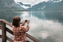  Tourist In A Plaid Shirt Takes A Picture Of A Lake With A Reflection, An Outdoor Recreation Concept, Hallstatt, Austria