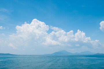 Wall Mural - white cloud and blue sky over the ocean . island view from the sea . summer tropical landscape .