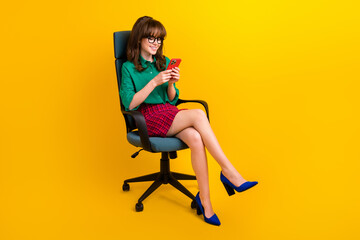 Poster - Full length photo of positive shiny woman dressed green shirt typing modern device empty space isolated yellow color background