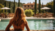© Keitma - Beautiful classy woman laying by the pool of a Tuscan Villa with luxury pool , background with cypress trees and beautiful vista