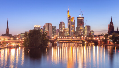 Wall Mural - Skyscrapers in Frankfurt am Main against the backdrop of the river at sunset.