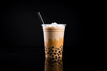 iced milk tea and bubble boba in the plastic glass on the dark background