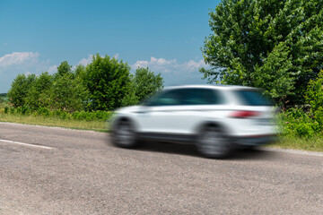 Sticker - White car driving fast in countryside, motion blur