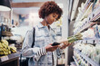 © Flamingo Images - Young woman shopping for vegetables in a grocery store