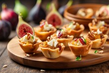 Tartlets With Figs And Cream Cheese On A Wooden Table
