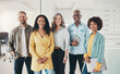 © Flamingo Images - Smiling team of diverse businesspeople standing together in an office