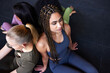 © Flamingo Images - Fit women sitting back to back on a gym floor