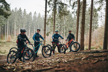Group Of Friends Riding Mountain Bike In A Forrest