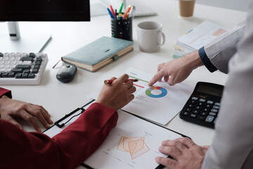 Aufkleber - Close up view of business team working at the table and discussing a new project with chart and graph.