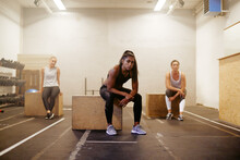 Diverse Group Of Women Sitting On Boxes In A Gym