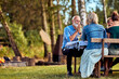 © Flamingo Images - Man talking with family outside at a table