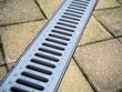 Stamped metal grating for drainage channel