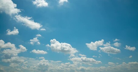 Wall Mural - Cloud blue sky background Time lapse Beautiful white clouds approach the point of view backed by a vivid blue sky in this one minute loop Time lapse raw photo interval at 1 second fade at video's end