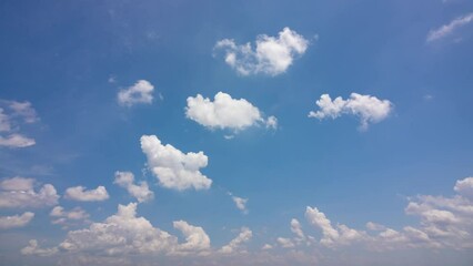 Wall Mural - Cloud blue sky background Time lapse Beautiful white clouds approach the point of view backed by a vivid blue sky in this one minute loop Time lapse raw photo interval at 1 second fade at video's end