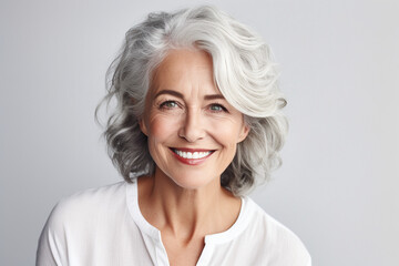 Portrait of Smiling confident stylish mature middle aged woman standing at home office. Old senior businesswoman, 60s gray-haired lady executive business leader manager looking at camera . High