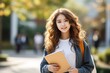 © Маргарита Вайс - Young attractive female student smiling with a folder in her hands. Nice wavy haired asian woman.