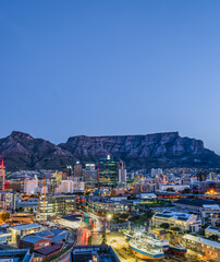 Wall Mural - Vertical long exposure shot of Cape Town city and the table mountain in the background with blue sky, Cape Town, South Africa