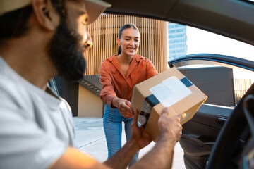 Wall Mural - Woman Receiving Parcel Box From Bearded Courier Guy In Car