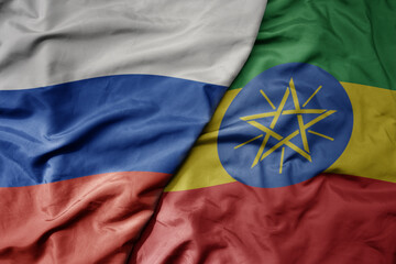 big waving realistic national colorful flag of russia and national flag of ethiopia .