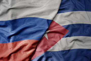 big waving realistic national colorful flag of russia and national flag of cuba .