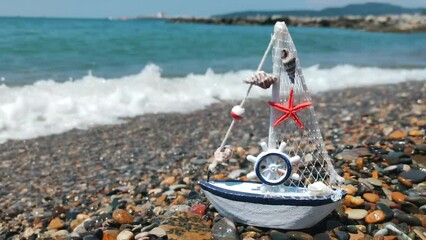 Canvas Print - Beautiful toy boat on the seashore.