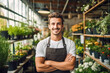 © MVProductions - A handsome young male florist gardener posing in greenhouse. Small business owner in flower shop