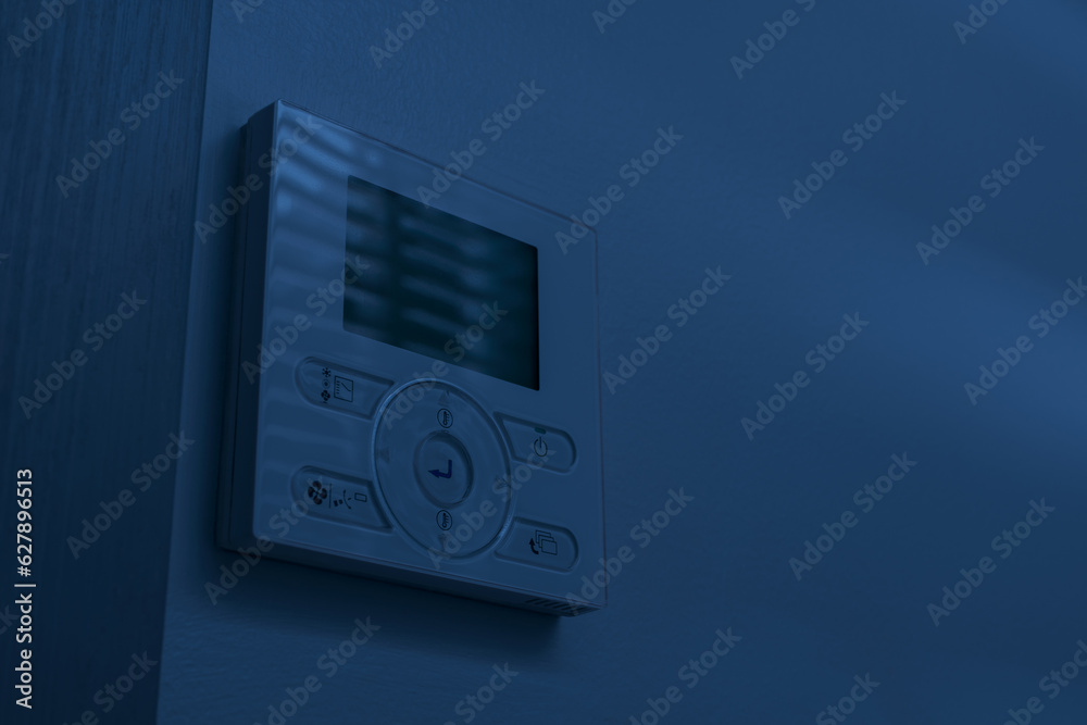 wall-mounted air-conditioning remote controller inside home or hotel at ...