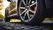 This close-up shot focuses on the car wheel's black rubber tire, highlighting its sturdy construction and reliable performance.