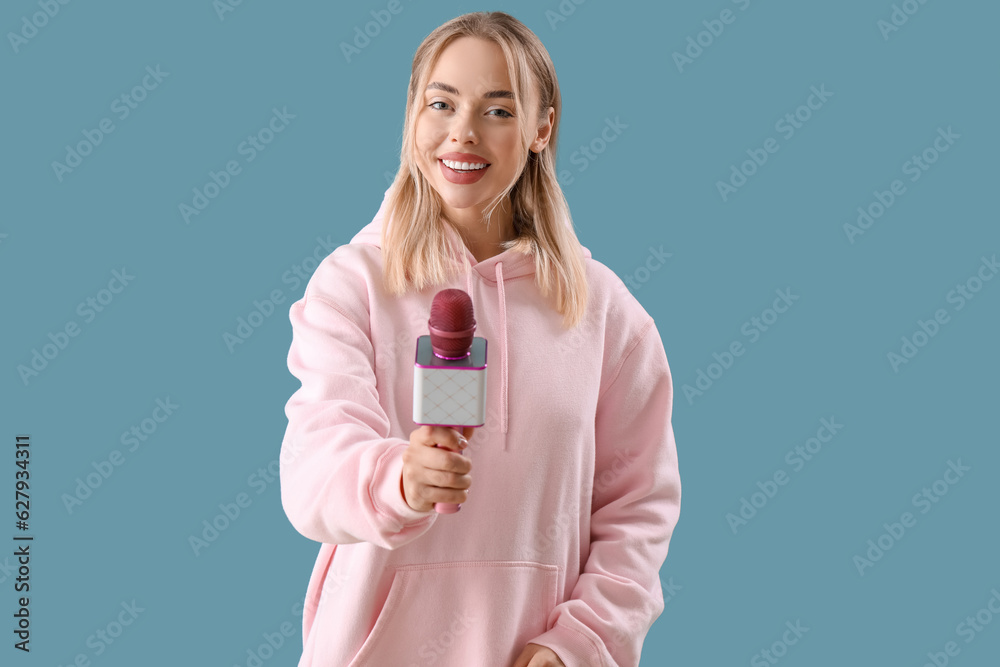 Female journalist with microphone on blue background