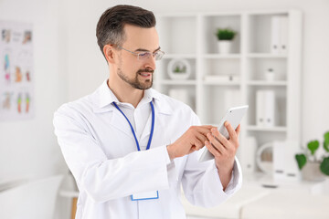 Wall Mural - Male physiotherapist using tablet computer in rehabilitation center