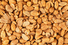 Roasted and salted peanuts as background, top view. Peeled and spicy peanuts.