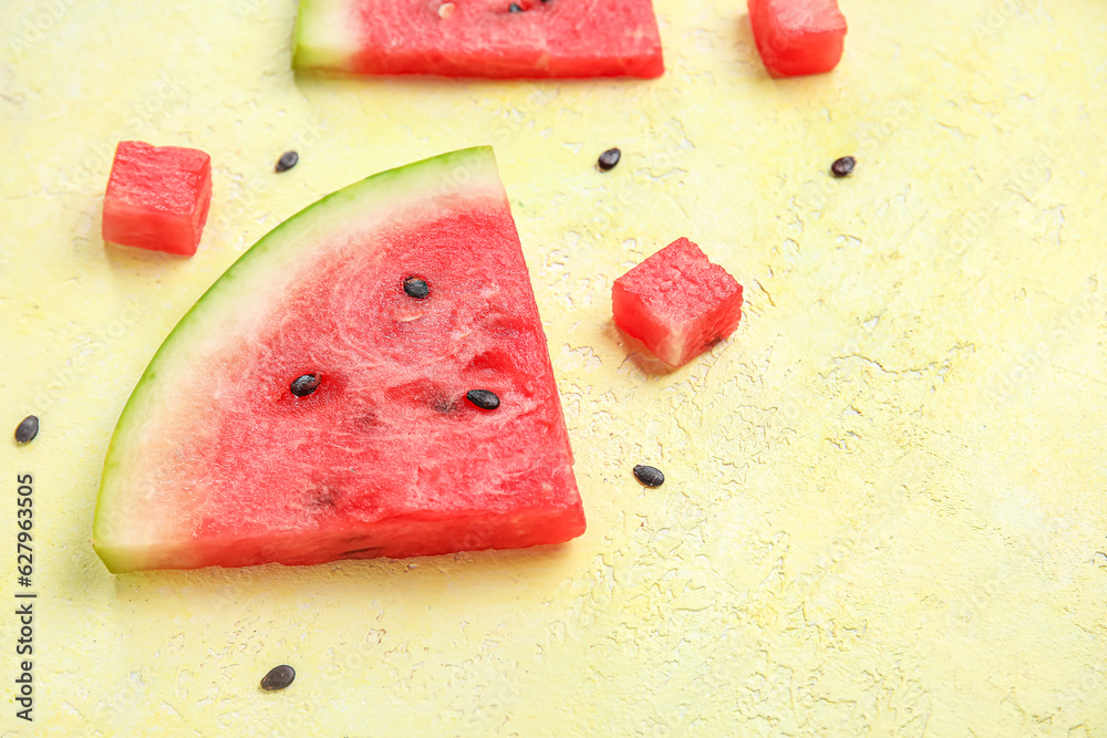 Composition with pieces of ripe watermelon on yellow background, closeup