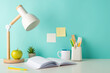 © ActionGP - Create an efficient workspace with a side-view photo showcasing white tabletop with student's essentials, including stationery in organizer and lamp on blue isolated backdrop, ideal for text or advert