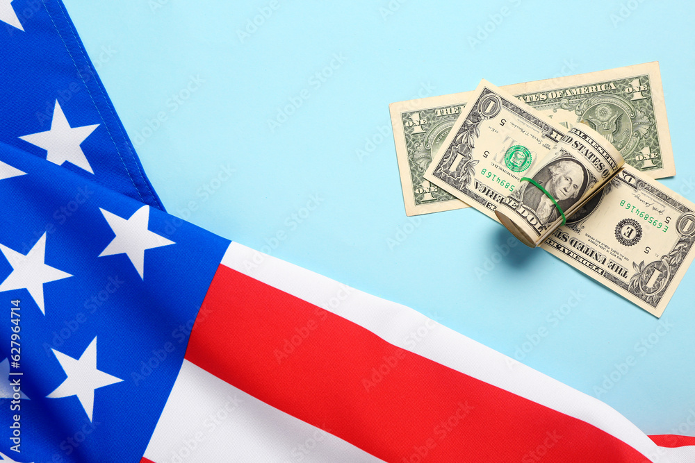 Flag of USA and dollar banknotes on blue background